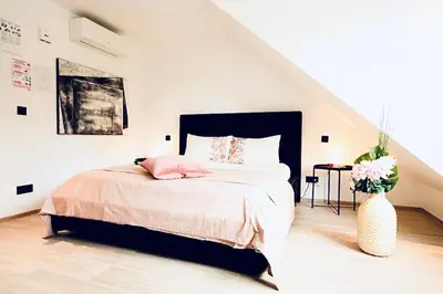 a bedroom with a bed and a vase with flowers at Résidence Palace Expo in Brussels