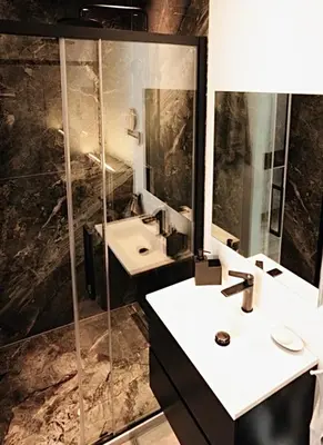 a bathroom with a sink and a shower and a mirror at Résidence Palace Expo in Brussels