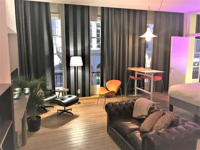 a living room with a couch and a bed at Ghent Centre Croft Deluxe in Ghent