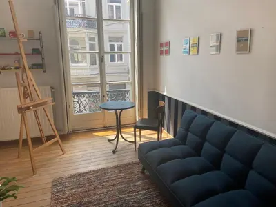 a living room with a couch and a table and a window at Ghent Centre Croft Deluxe in Ghent