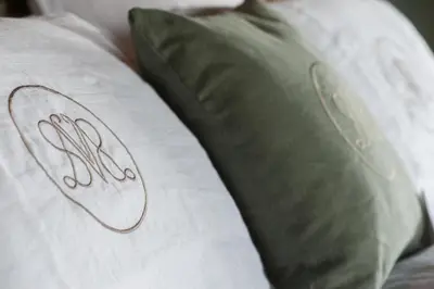 a bed with a pillow with aemed at Villa Servais in Halle