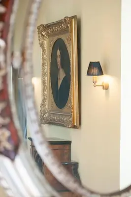 a mirror with a picture of a woman on a wall at Villa Servais in Halle