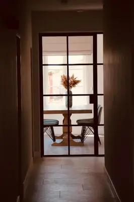a dining room with a table and a window at B&B Biesvenhof in Merksplas