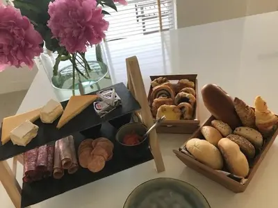 a table with several different types of bread and pastries at B&B Biesvenhof in Merksplas