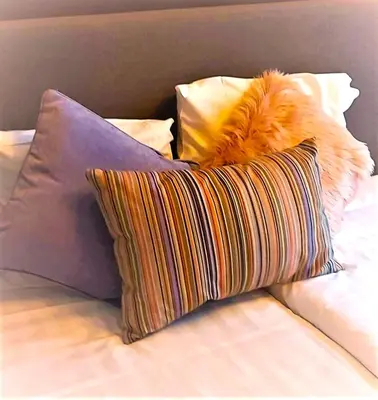 a pile of pillows sitting on top of a bed at Mezonvin in Antwerp