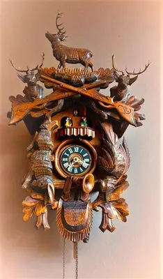 a wooden clock with deer on a wall at Mezonvin in Antwerp