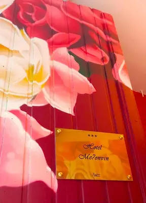 a yellow sign on a red umbrella with a flower at Mezonvin in Antwerp