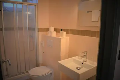 a bathroom with a toilet and a sink and a shower at Mezonvin in Antwerp