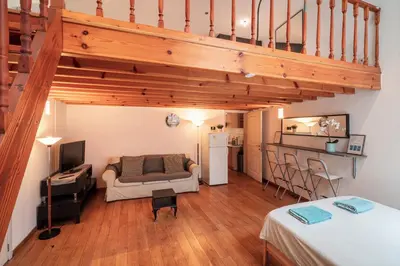 a living room with a couch and a staircase at Saint Paulus Square Apartments in Antwerp