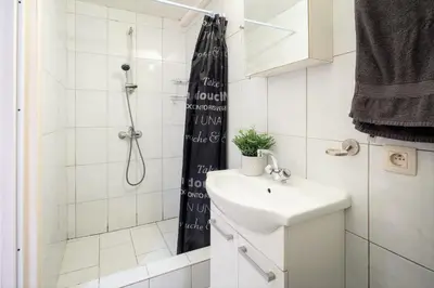 a small bathroom with a sink and a shower at Saint Paulus Square Apartments in Antwerp