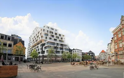 a large white building in the middle of a city at Saint Paulus Square Apartments in Antwerp