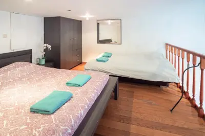 a room with two beds and a staircase with two beds at Saint Paulus Square Apartments in Antwerp