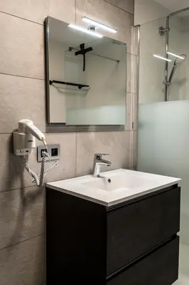 a bathroom with a sink and a mirror at Guesthouse Max in Burcht