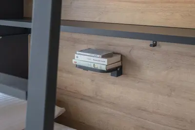 a stack of books sitting on a wall at LATROUPE Grand Place in Brussels