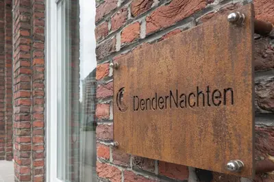a sign on the side of a brick building at Dendernachten in Dendermonde