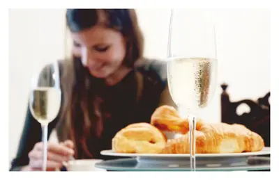 a woman sitting at a table with two glasses of wine at Dendernachten in Dendermonde