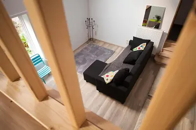 an aerial view of a living room with a black couch at B&B t'Keygoed in Ghent