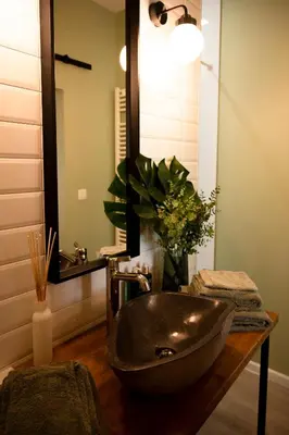 a bathroom with a sink and a mirror at B&B De Koepoort in Mechelen