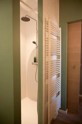 a bathroom with a shower with a glass door at B&B De Koepoort in Mechelen