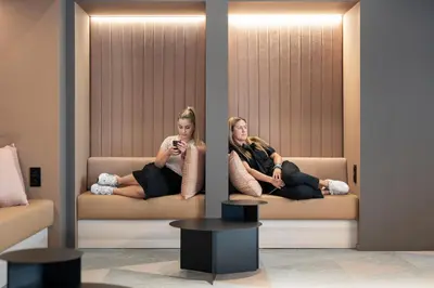 two women sitting on a couch in a room at Citybox Antwerp City Center in Antwerp