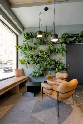 a room with chairs and plants on the wall at Citybox Antwerp City Center in Antwerp