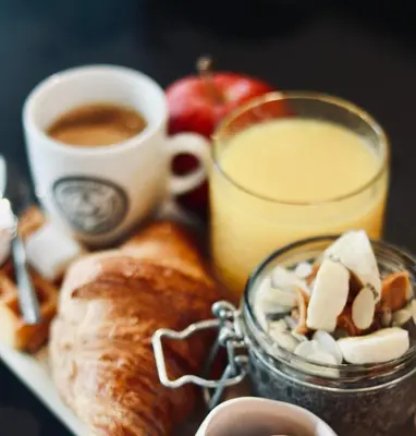 a plate of food with bread and a cup of coffee at Citybox Antwerp City Center in Antwerp