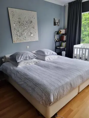 a bedroom with a large bed with white sheets and pillows at Magnifique appartement- Brussels expo Laeken in Brussels