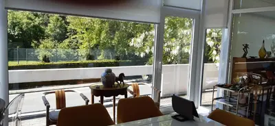a room with a large window with a table and chairs at Magnifique appartement- Brussels expo Laeken in Brussels