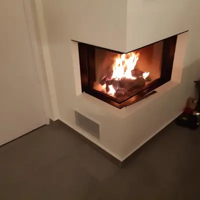 a fireplace in a wall with a fire in it at Magnifique appartement- Brussels expo Laeken in Brussels