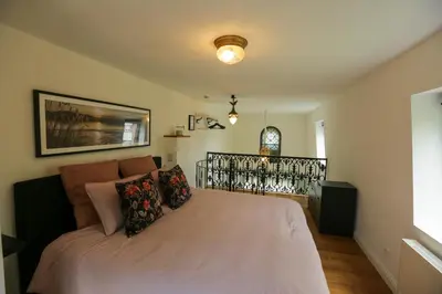 a bedroom with a large bed with pillows on it at Amand'eau - zwemvijver, zonneterras, grote tuin in Sint-Amands