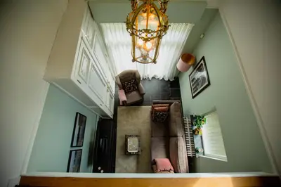 an overhead view of a hallway with chairs and a chandelier at Amand'eau - zwemvijver, zonneterras, grote tuin in Sint-Amands