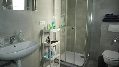 a bathroom with a shower and a sink and a toilet at Roosevelt Apartments. in Antwerp