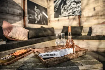 a room with a table with a bottle of wine and glasses at Backstage in Haacht
