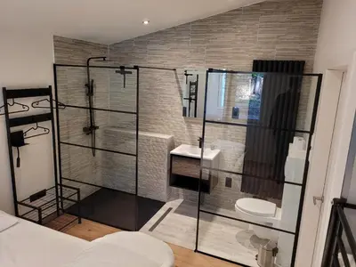 a bathroom with a glass shower and a toilet at Hogenberg Heiken Lichtaart Kasterlee met eigen laadpaal in Lichtaart