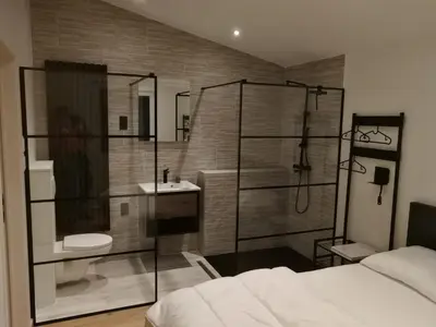 a bathroom with a shower and a toilet and a sink at Hogenberg Heiken Lichtaart Kasterlee met eigen laadpaal in Lichtaart