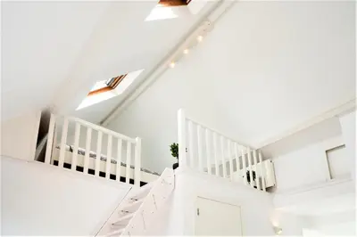 a white staircase in a home with white ceilings at Beautiful Terrace Apartment in the Heart of Antwerp in Antwerp