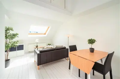 a living room with a table and a couch at Beautiful Terrace Apartment in the Heart of Antwerp in Antwerp