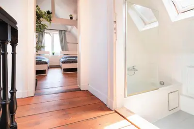 a bathroom with a shower and a bath tub at Antwerp Old Town Centrum Apartment in Antwerp