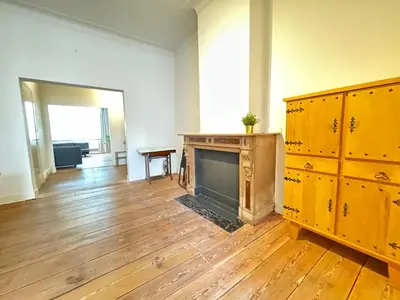 a living room with a fireplace and wooden cabinets at Antwerp Old Town Centrum Apartment in Antwerp
