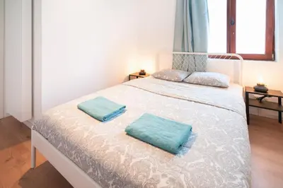 a bedroom with a bed with two pillows on it at Saint Pauls Central Residence in Antwerp