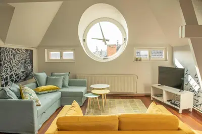 a living room with a couch and a tv at Beautiful city center apartments in Ghent near medieval castle in Ghent