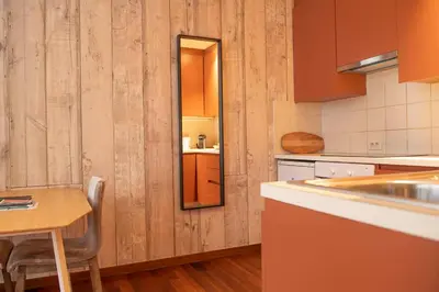 a kitchen with a sink and a table with a mirror at Beautiful city center apartments in Ghent near medieval castle in Ghent