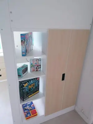 a book shelf with toys and games on it at Rent & Relax in Mol