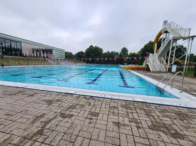 a large swimming pool with a water slide at Rent & Relax in Mol