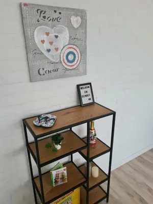 a small table in a room with a picture on the wall at Rent & Relax in Mol