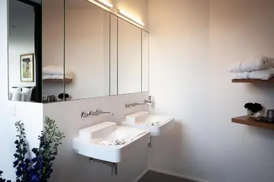 a bathroom with two sinks and a mirror at Suite Aux Anges in Antwerp