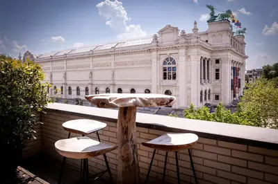 a couple of stools sitting on a ledge in front of a building at Suite Aux Anges in Antwerp