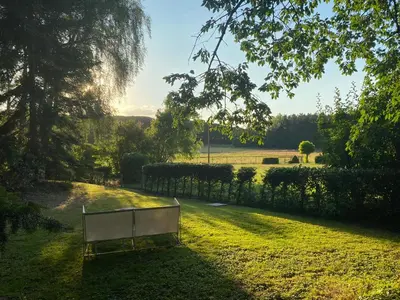 a bench in the middle of a grass field at B&B Miranoza in Oud-Heverlee