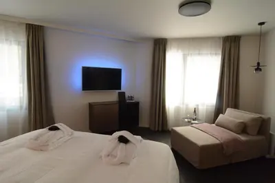 a hotel room with two beds and a flat screen tv at B&B Miranoza in Oud-Heverlee