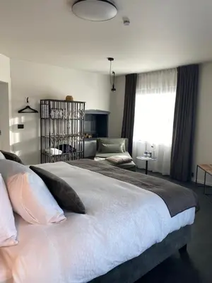a bedroom with a large white bed and a window at B&B Miranoza in Oud-Heverlee